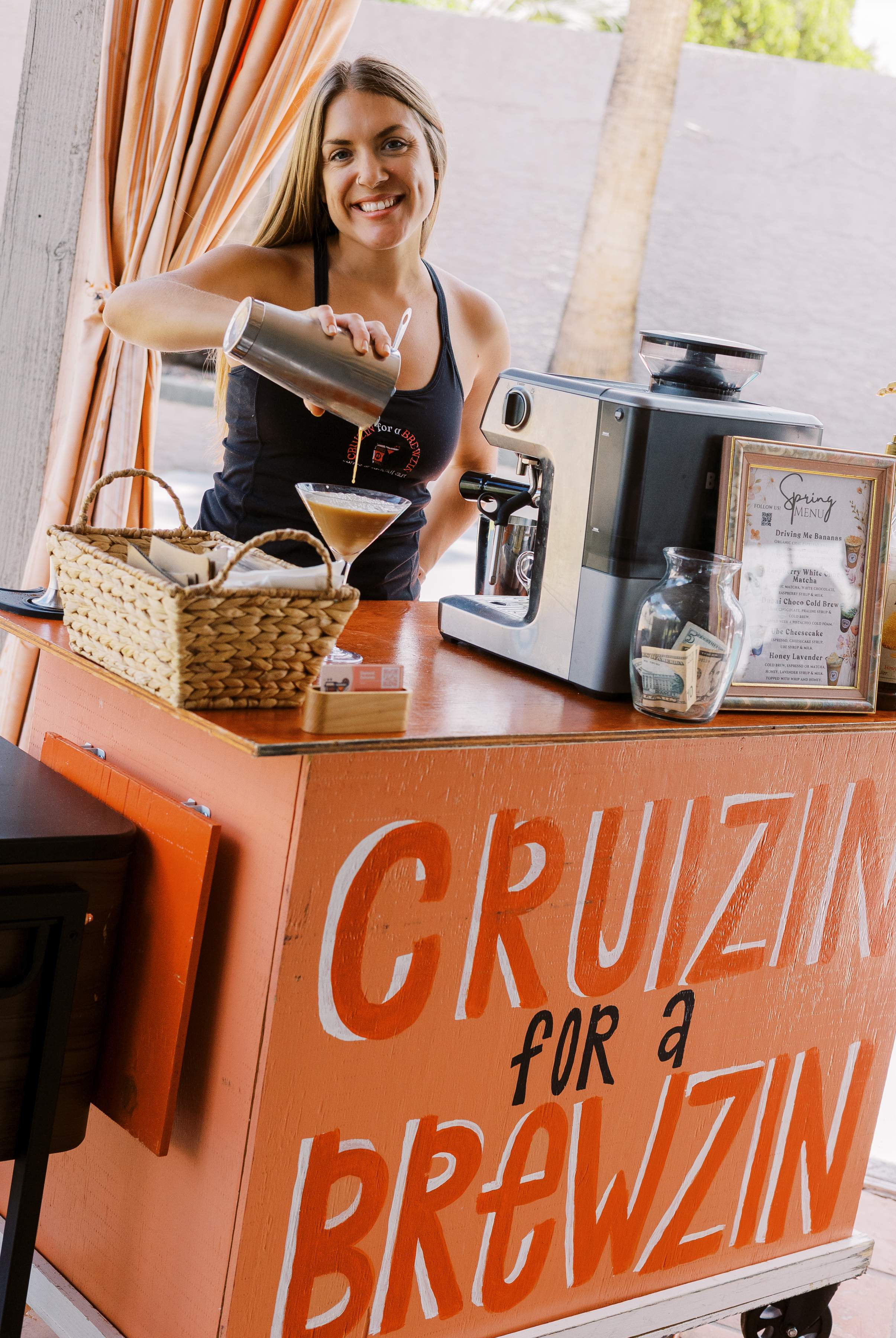 Diamond serving champagne and mimosas behind the Cruizin for a Brewzin mobile bar cart